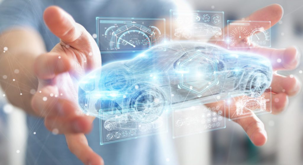 Hands holding a digital illustration of a connected car