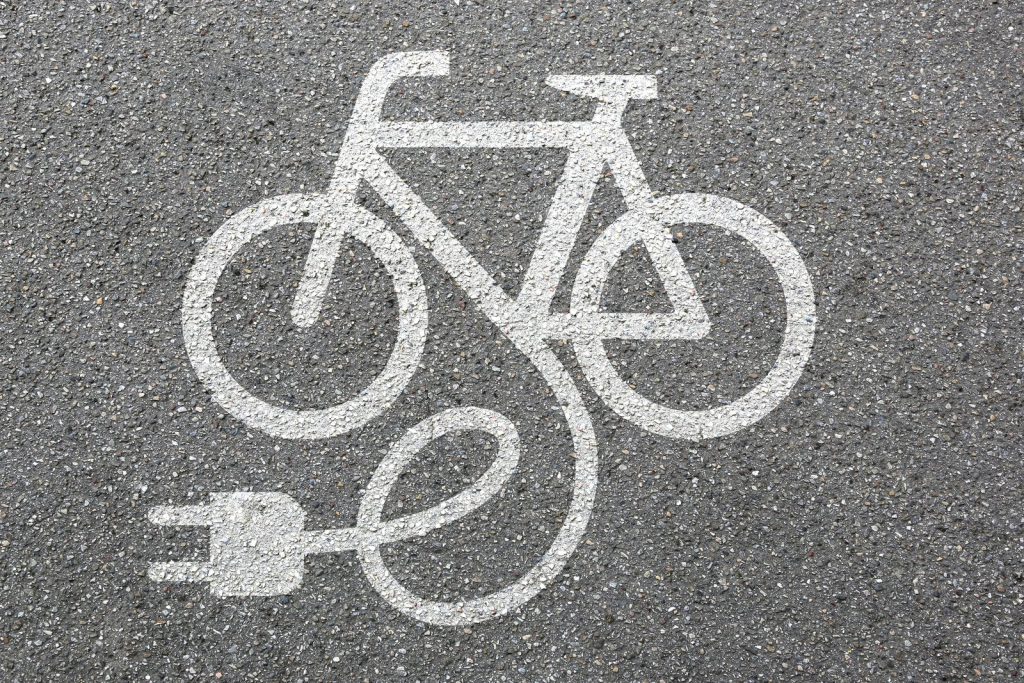 E-bike charging symbol painted on a cycle path