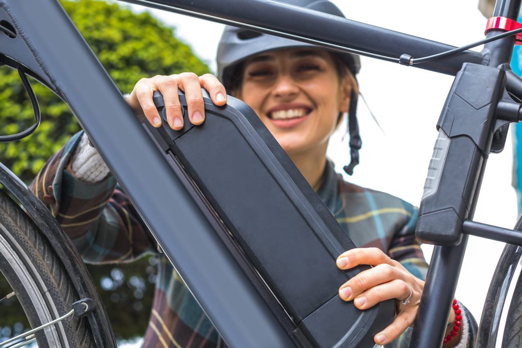 Cyclist removing the battery from an e-bike